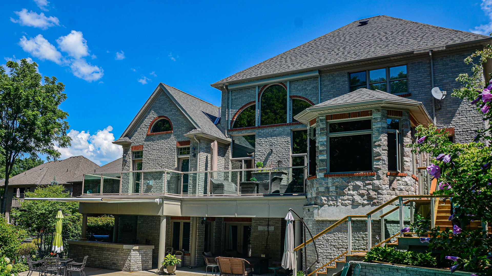 Luxury home with extensive glass windows and railings